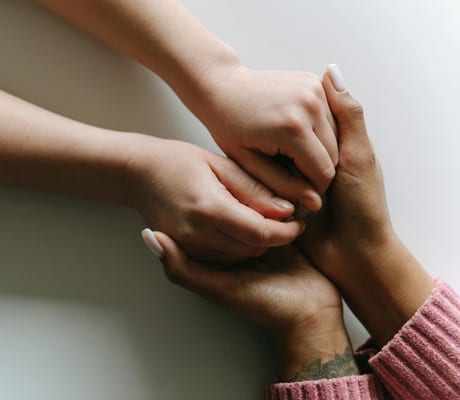 One person holding another’s hands